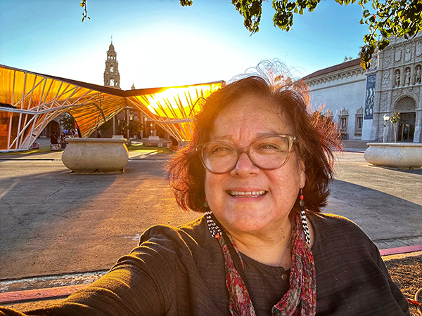 woman stands in front of poetry exhbit